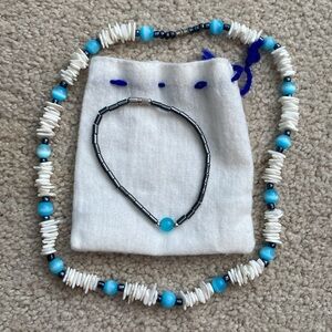 Necklace and bracelet set with storage bag.